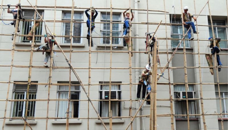 A group of scaffolders working on bamboo scaffolding in Hong Kong.